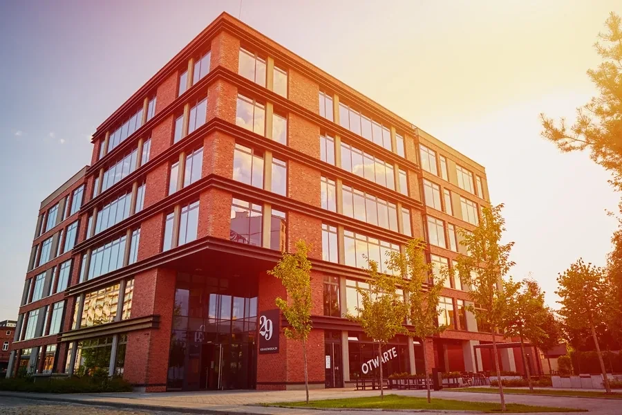 Red brick commercial office building glowing in warm sunset light